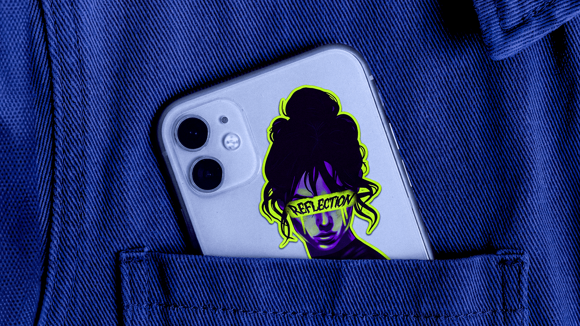 A die-cut sticker applied to a phone, tucked into a denim jacket pocket