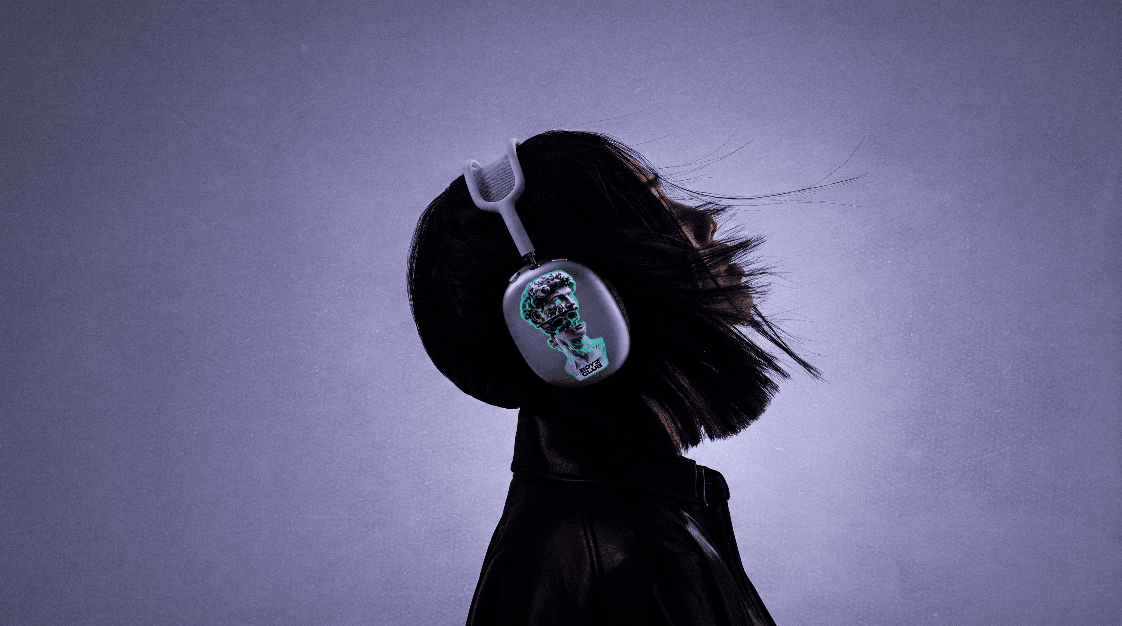 A sticker applied to a pair of over-ear headphones, worn outdoors