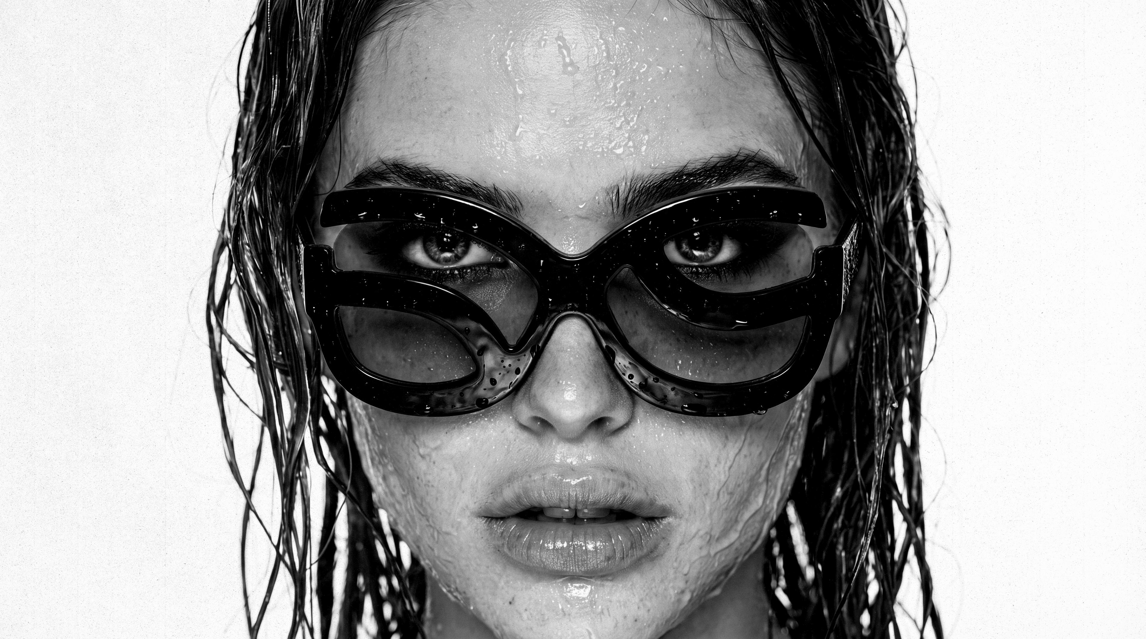 Close-up portrait wearing LXIX sunglasses, water droplets on skin
