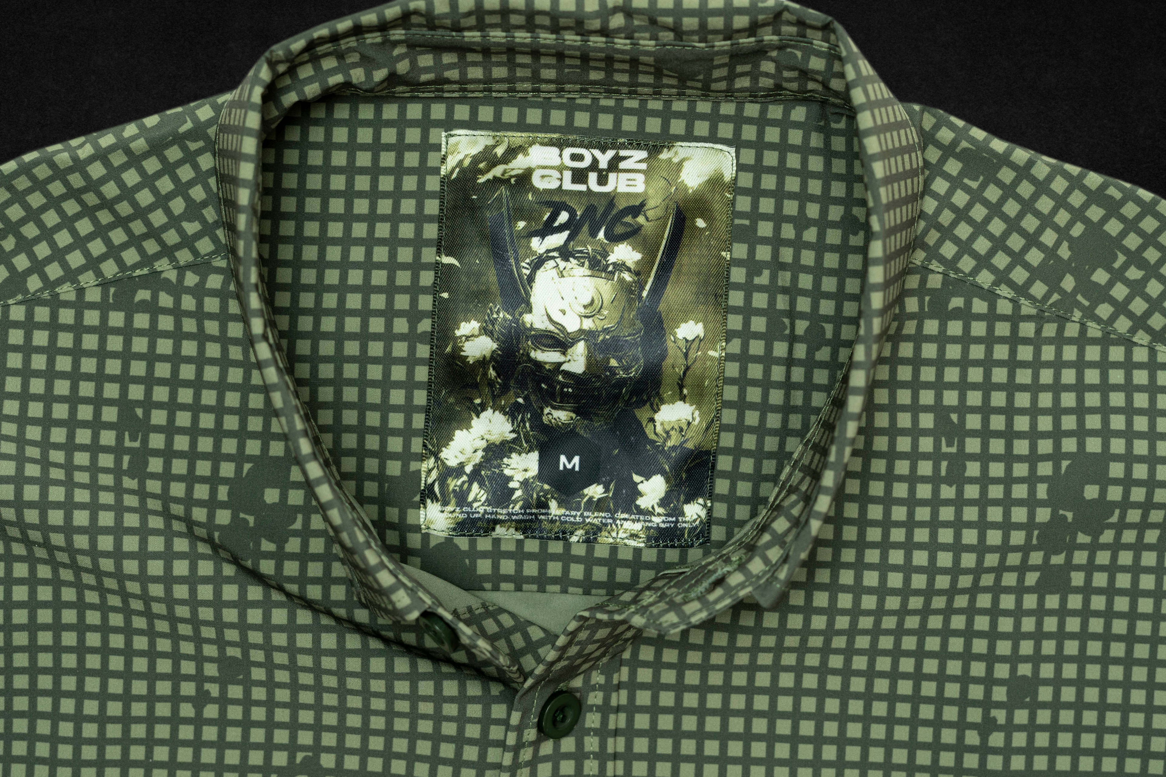 DNC tag sewn into an olive camouflage garment collar