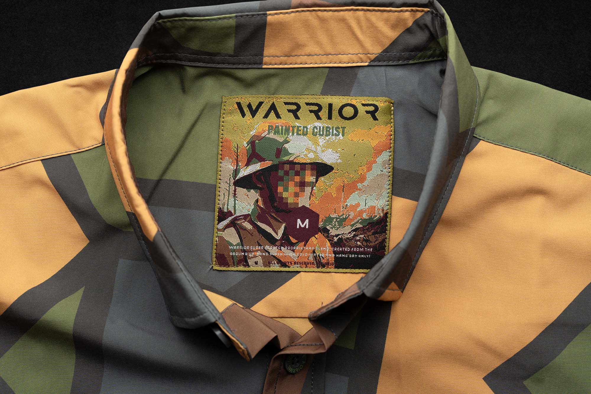Painted Cubist tag sewn into a camouflage garment collar