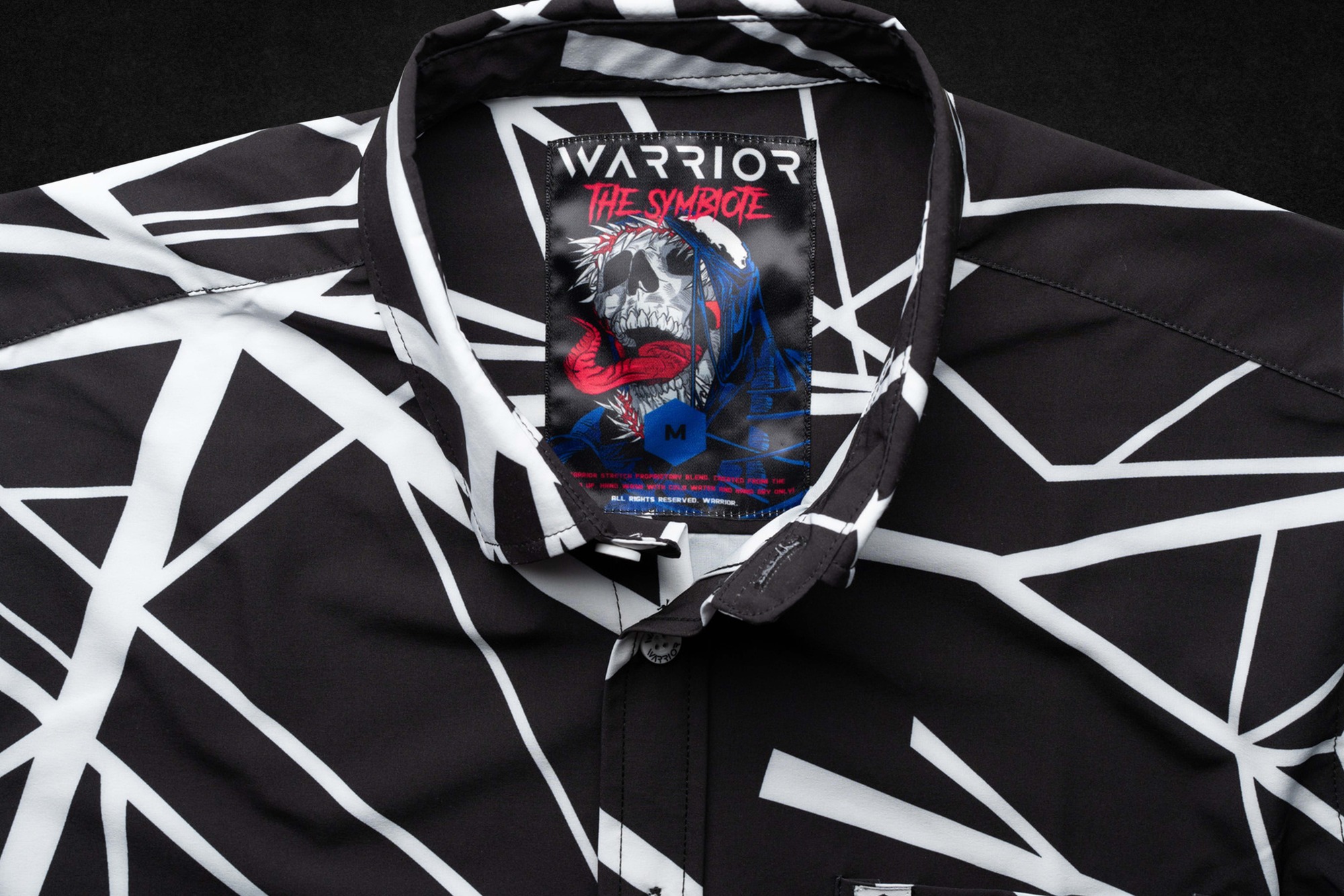 The Symbiote tag sewn into a black and white garment collar