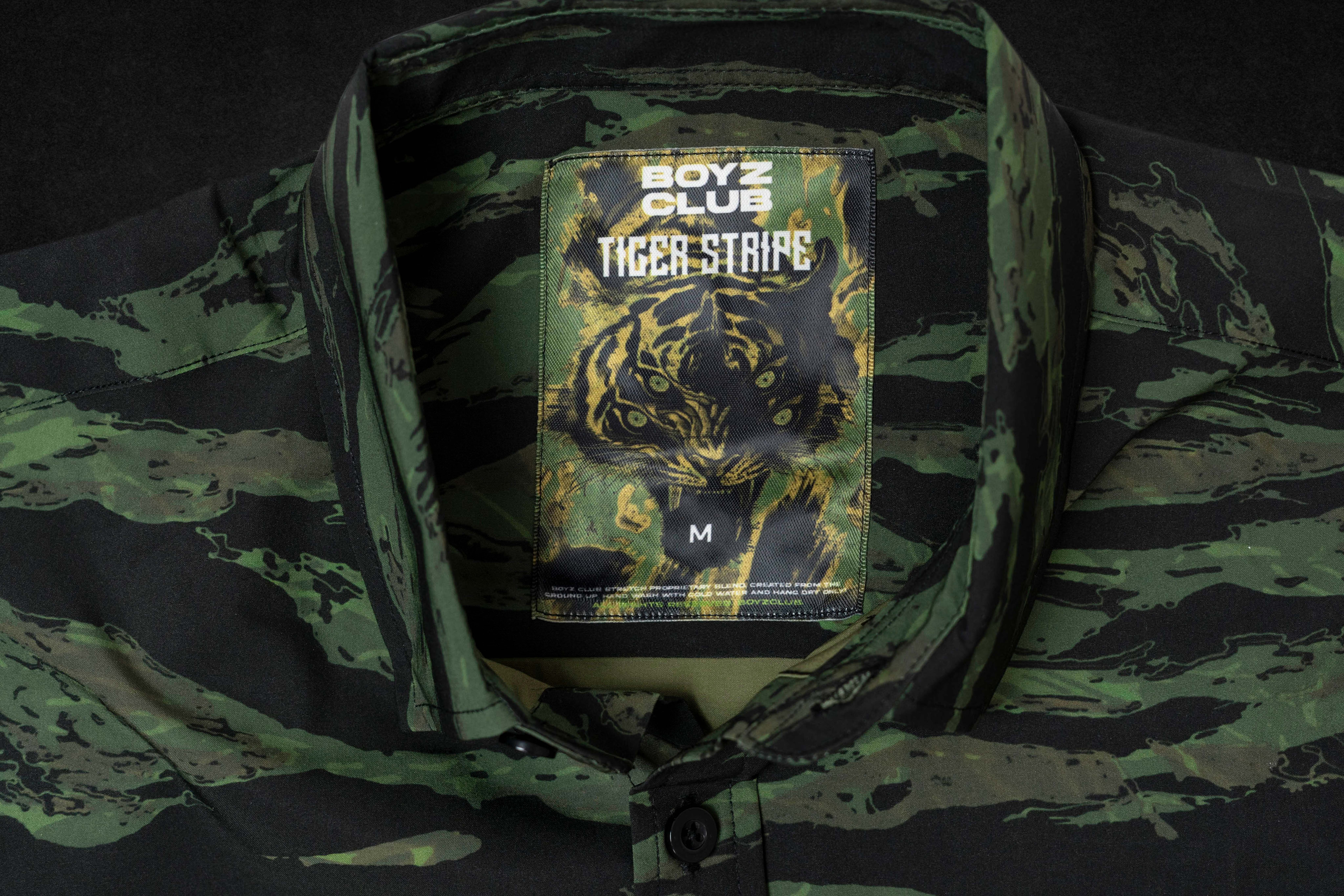 Tiger Stripe tag sewn into a green tiger-camo garment collar